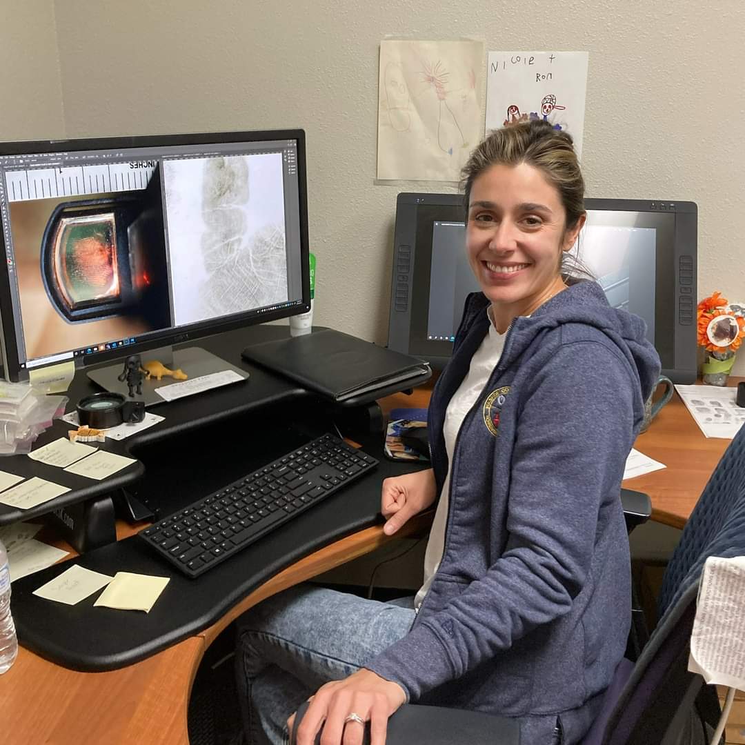 Analyst looking at enlarged fingerprints on a computer screen